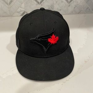 Blacked out Toronto Blue Jays hat with red maple leaf
